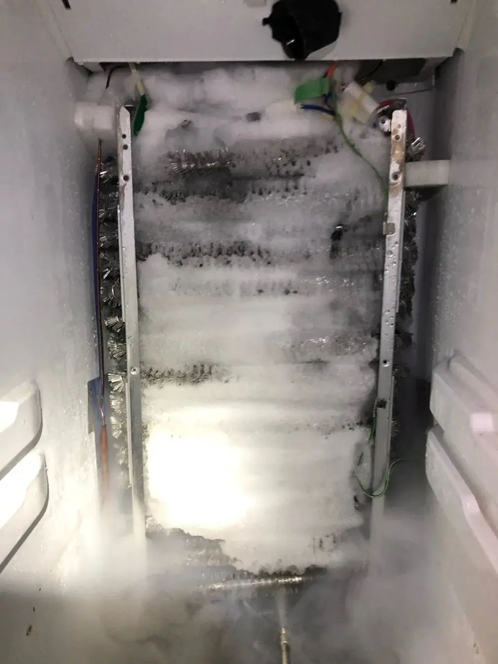 Mr. Fixer technician performing refrigerator freezer repair