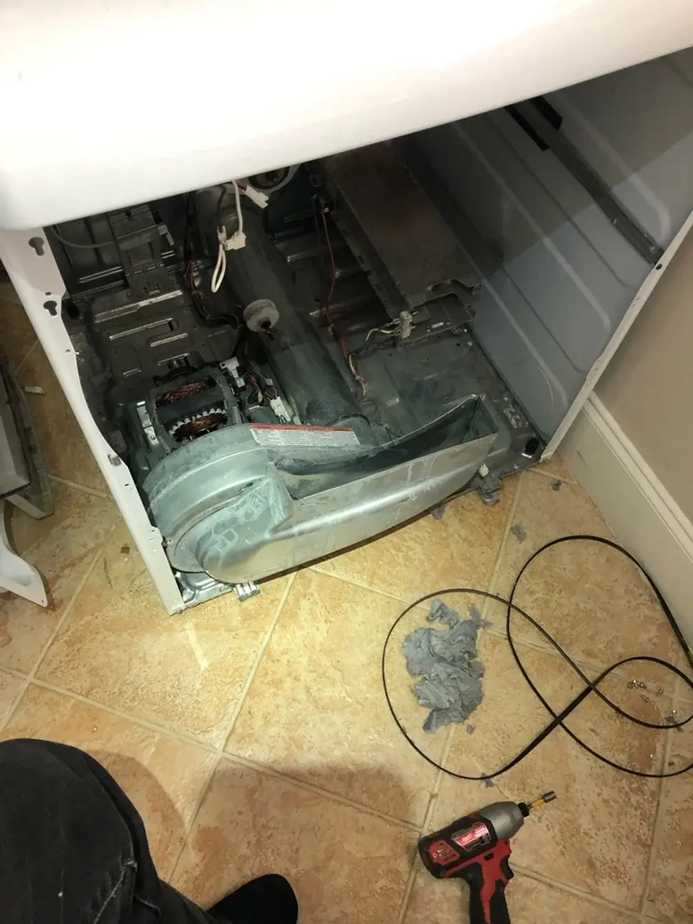 Mr. Fixer technician repairing a Fisher & Paykel appliance