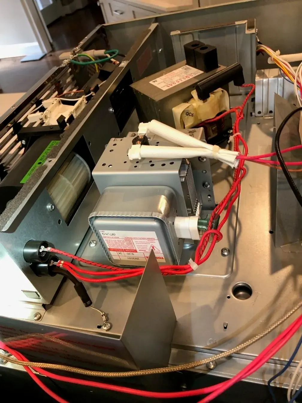 Mr. Fixer technician repairing a Sharp appliance
