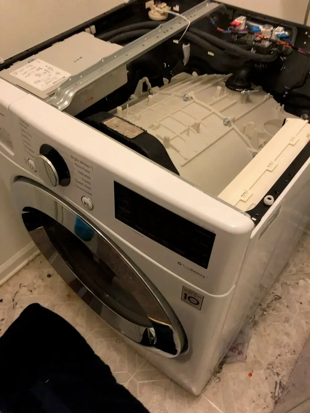 Mr. Fixer technician repairing a Whirlpool appliance